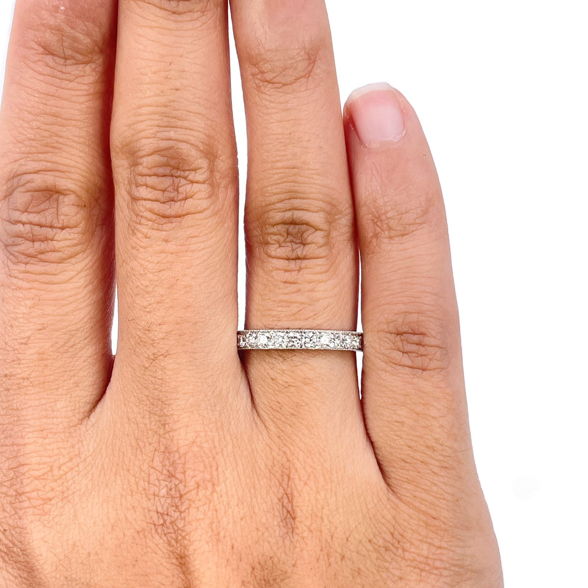 Close-up of round diamonds and milgrain edging on 18ct white gold half eternity ring